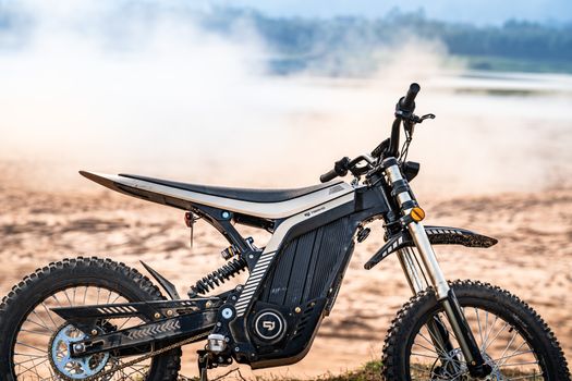 Stark VARG electric motocross bike mid-air on dirt track with suspension compressed