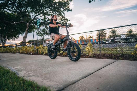 Senior woman securing electric bike with heavy duty lock in urban setting