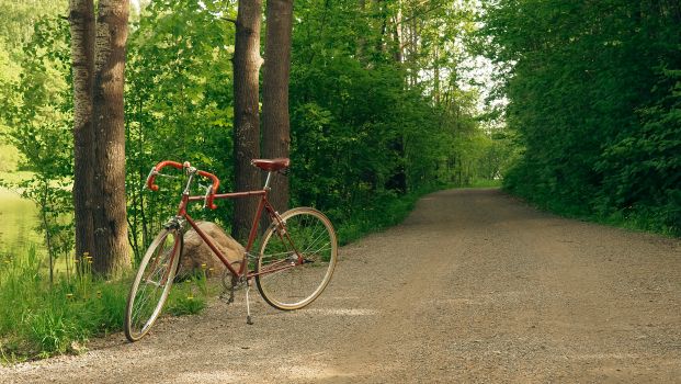 Rider on fat tire ebike navigating deep gravel ruts on a rural dirt road