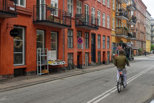 Short rider on step-through electric bike in city traffic