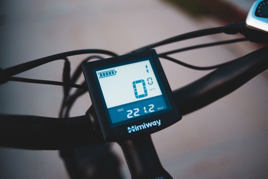 Cyclist wearing ebike helmet with bluetooth riding in city traffic